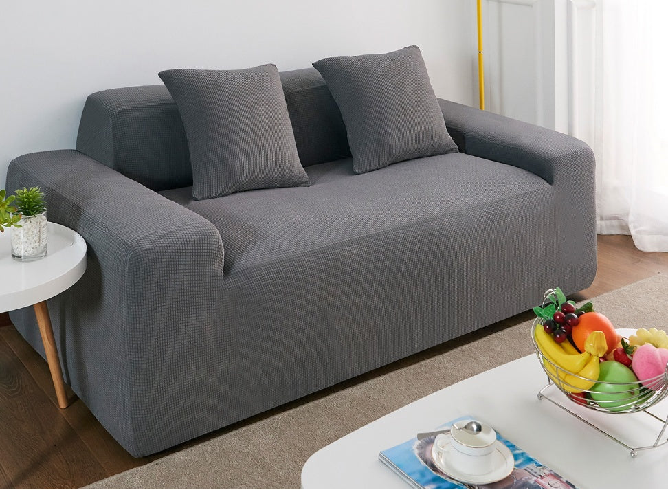 Shopi Vella grey waterproof sofa slipcover fitted on modern two-seater sofa with cushions in living room