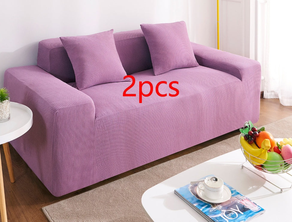 Shopi Vella waterproof sofa slipcover in purple covering a three-seat sofa with two matching pillows