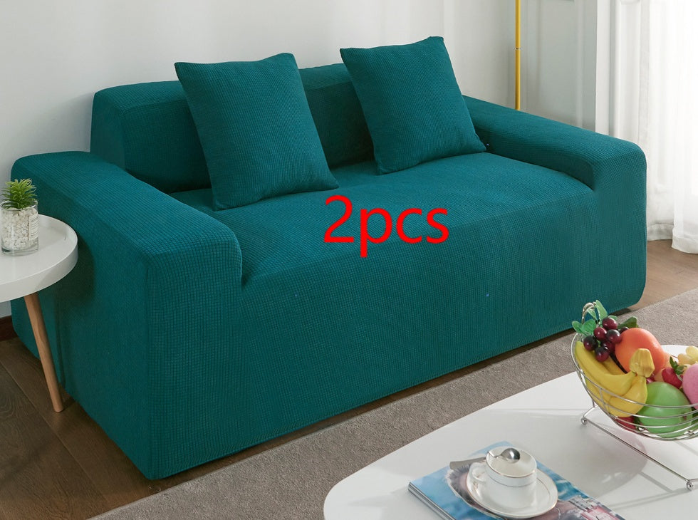 Teal waterproof sofa slipcover on modern sofa with matching cushions in living room