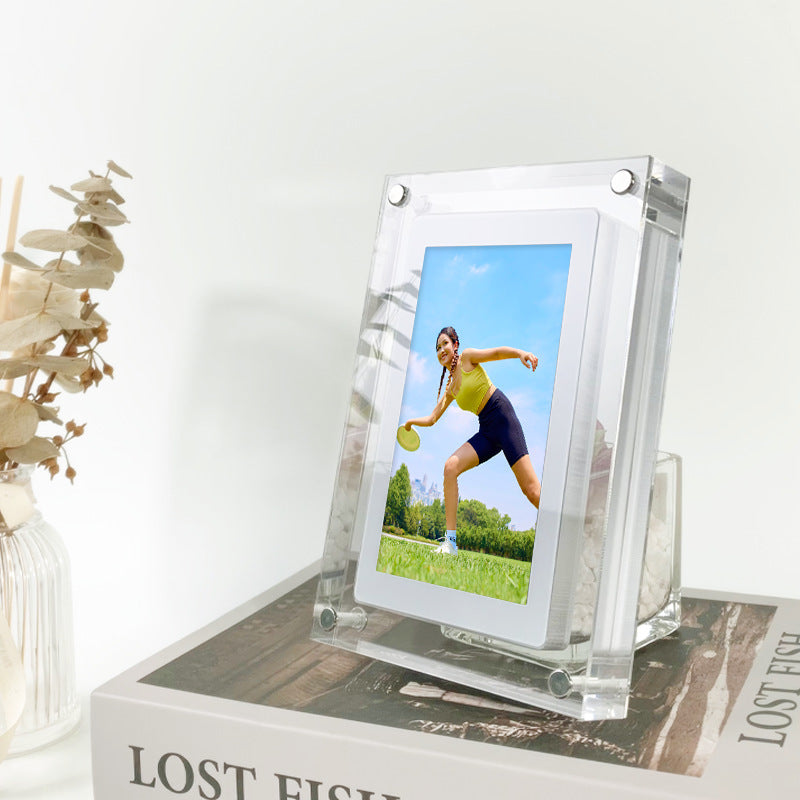 Shopi Vella vertical digital photo frame with battery displaying outdoor sports photo on a wooden table