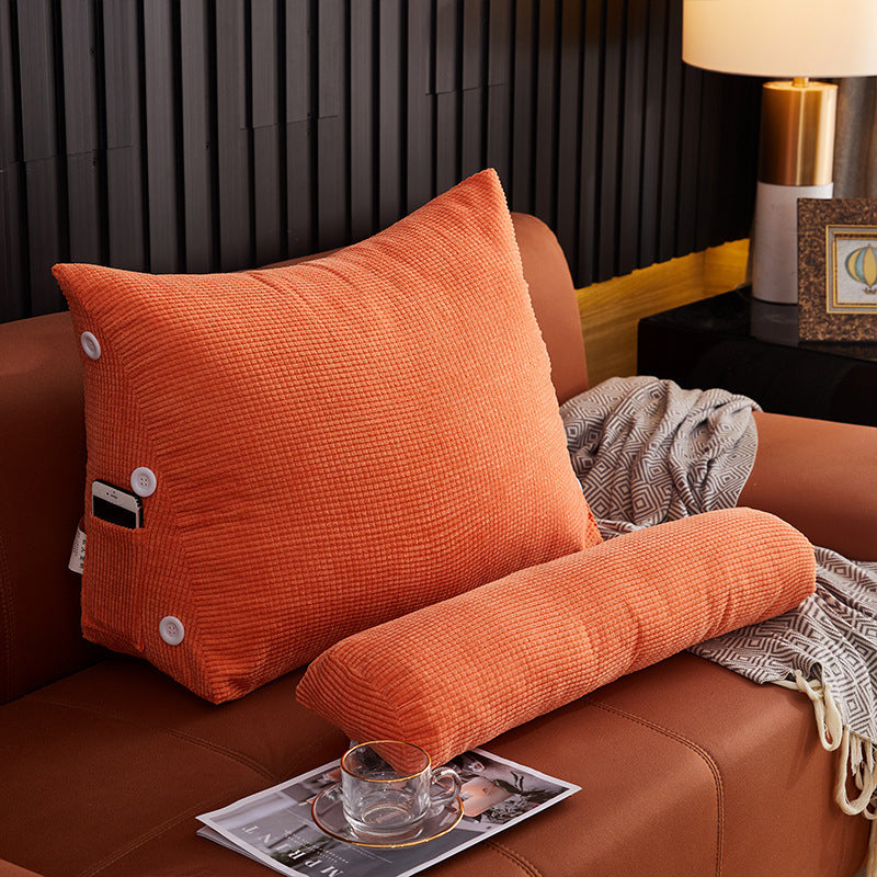 Shopi Vella orange pillow case on a waist backrest pillow placed on brown sofa with side pocket