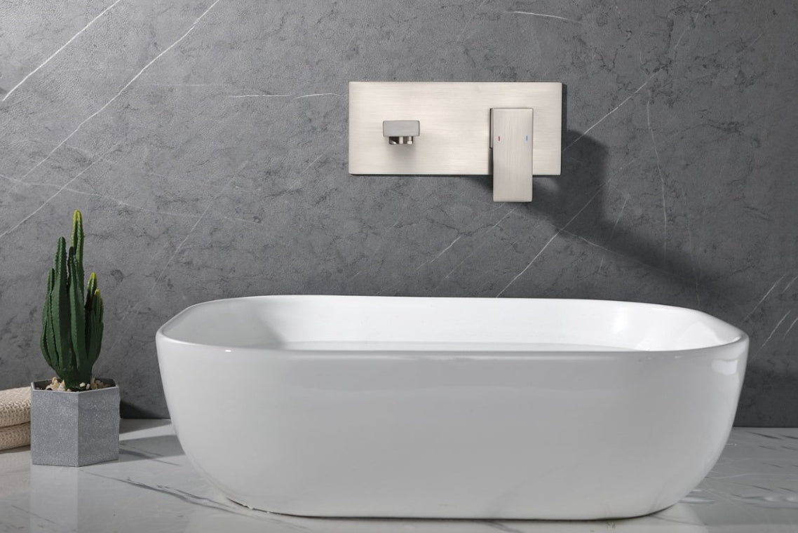Shopi Vella wall mount bathroom faucet brushed nickel installed above a modern white bathtub with gray marble wall background
