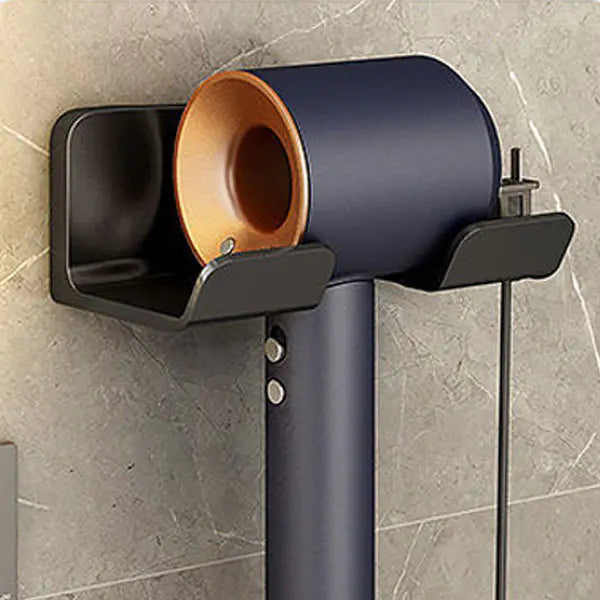 Black wall mounted bathroom hair dryer rack holding a modern hair dryer on a tiled wall