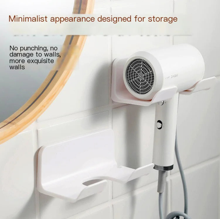 Wall mounted bathroom hair dryer rack in white holding a hair dryer on tiled bathroom wall
