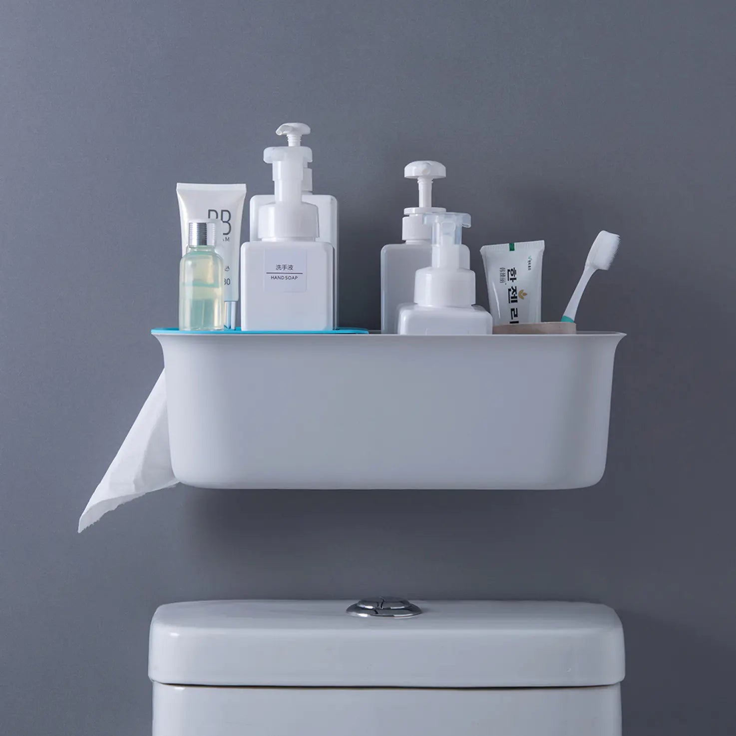 Wall mounted bathroom storage rack holding toiletries above a toilet with gray wall background