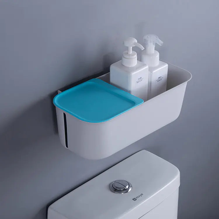 Wall mounted bathroom storage rack in white with blue lid holding soap dispensers above toilet