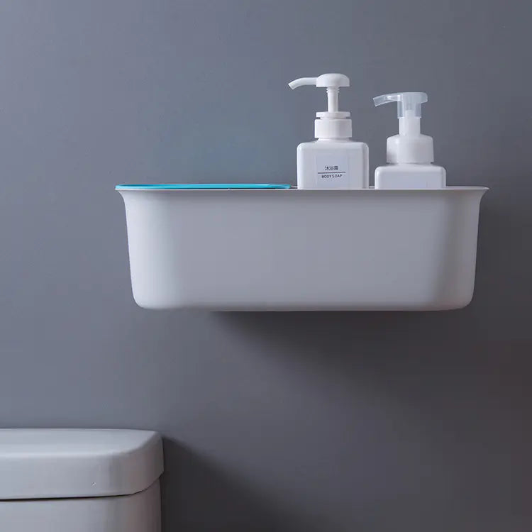 Minimalist white wall mounted bathroom storage rack holding soap dispensers and a blue item against gray wall