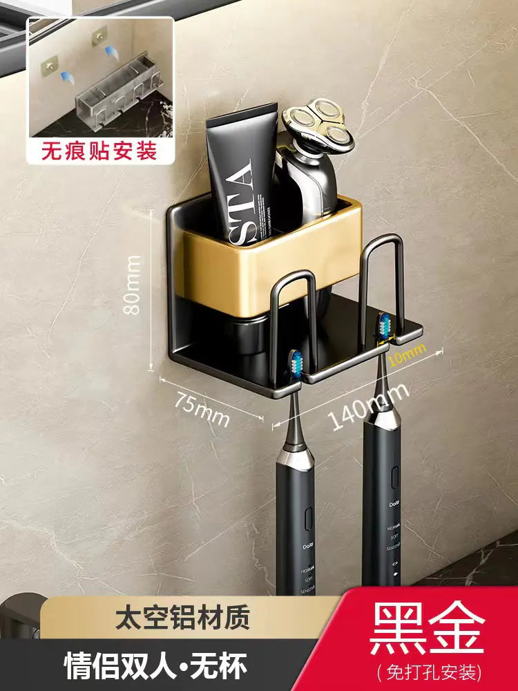 Wall-mounted toothbrush holder in black and gold with compartments for electric toothbrushes and razors