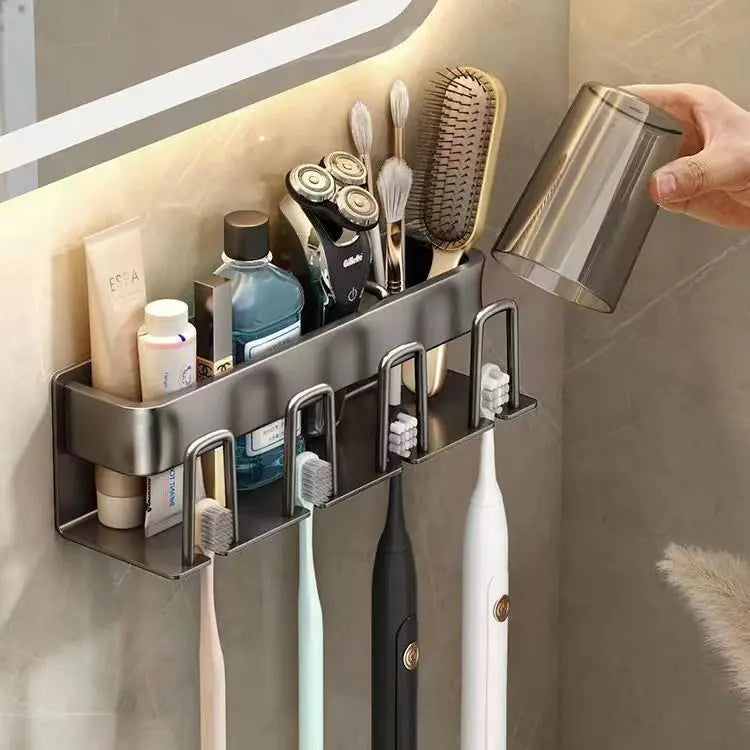 Wall-mounted toothbrush holder with multiple compartments holding electric shavers, toothbrushes, and grooming accessories