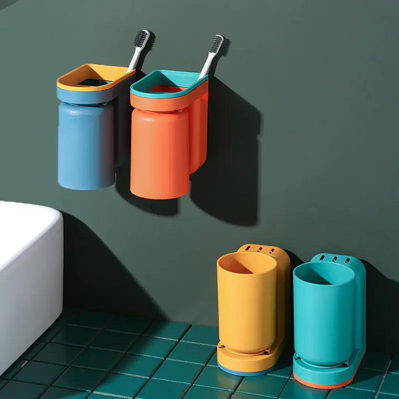 Colorful wall-mounted toothbrush holder with two toothbrushes attached to a dark green bathroom wall