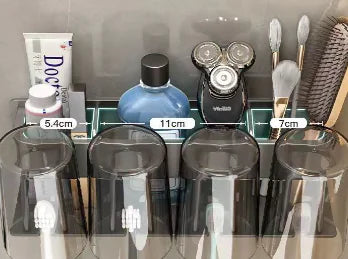 Wall-mounted toothbrush holder with four transparent cups and compartments for toothpaste and shaving tools