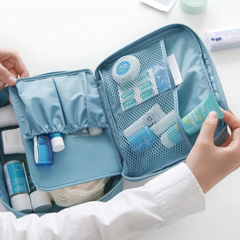 Shopi Vella waterproof cosmetic organizer with pockets in blue holding skincare and travel bottles