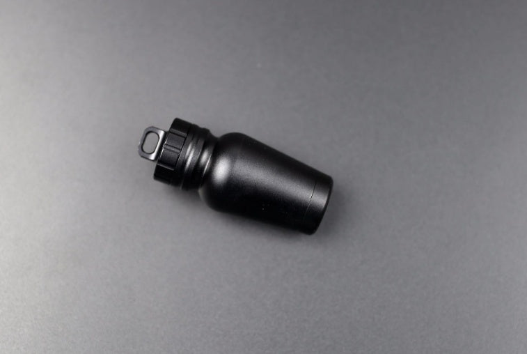 Shopi Vella black waterproof medicine bottle for outdoors with secure screw cap on gray background