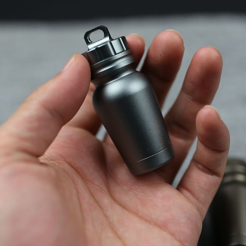 Shopi Vella waterproof medicine bottle for outdoors in small compact black design held in hand