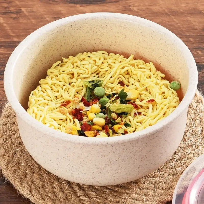 Shopi Vella wheat straw food storage bowls filled with instant noodles and vegetables on a woven placemat