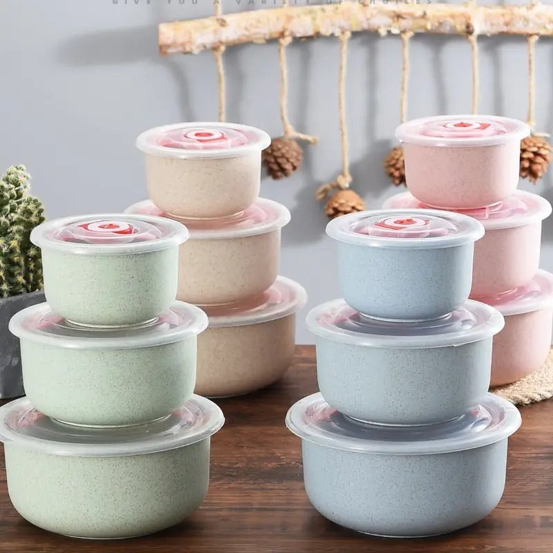Shopi Vella wheat straw food storage bowls in pastel colors with airtight lids stacked on wooden surface