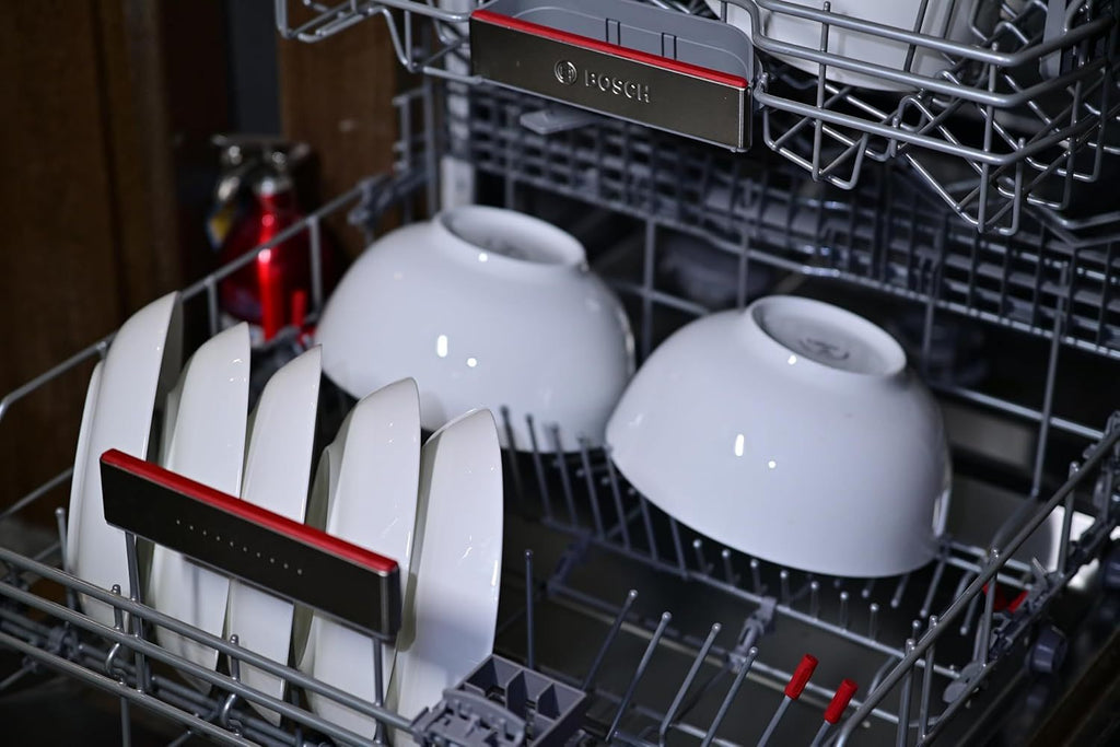 White dinnerware set for 4 including plates and bowls inside a dishwasher