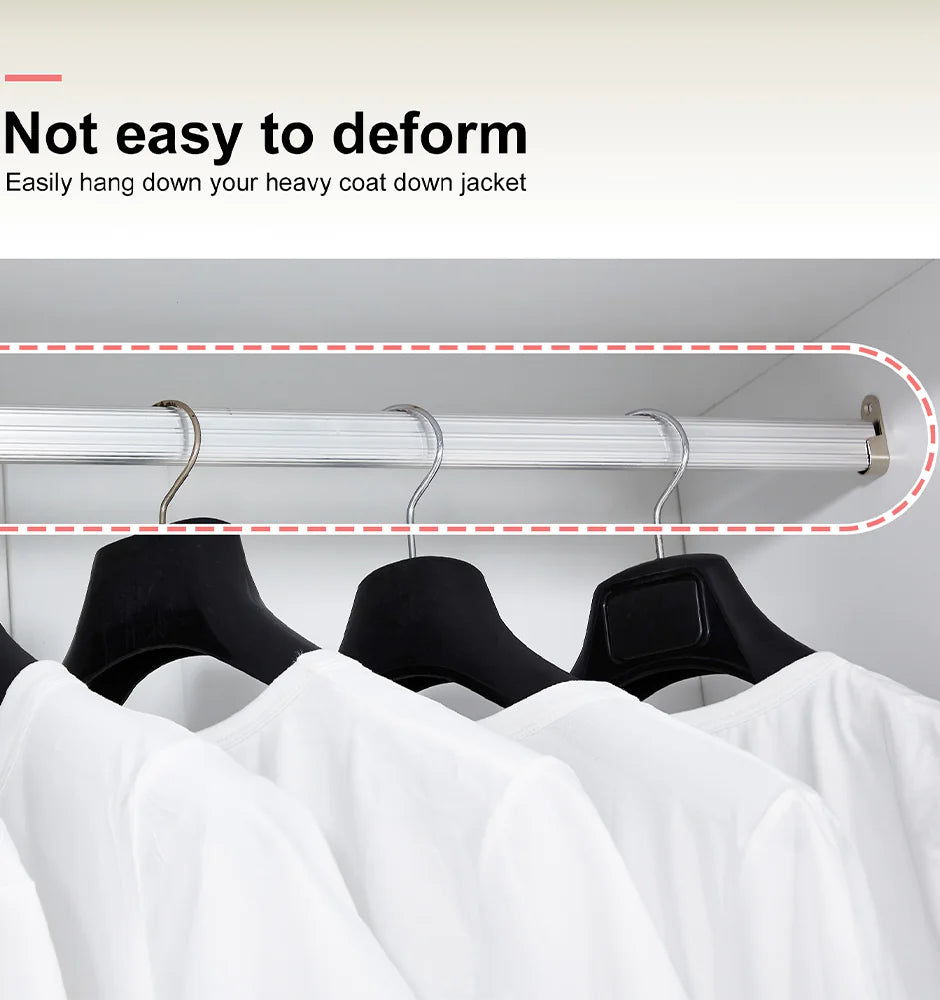 Sturdy hanging rod with white shirts in a white solid wood wardrobe closet supporting heavy coats