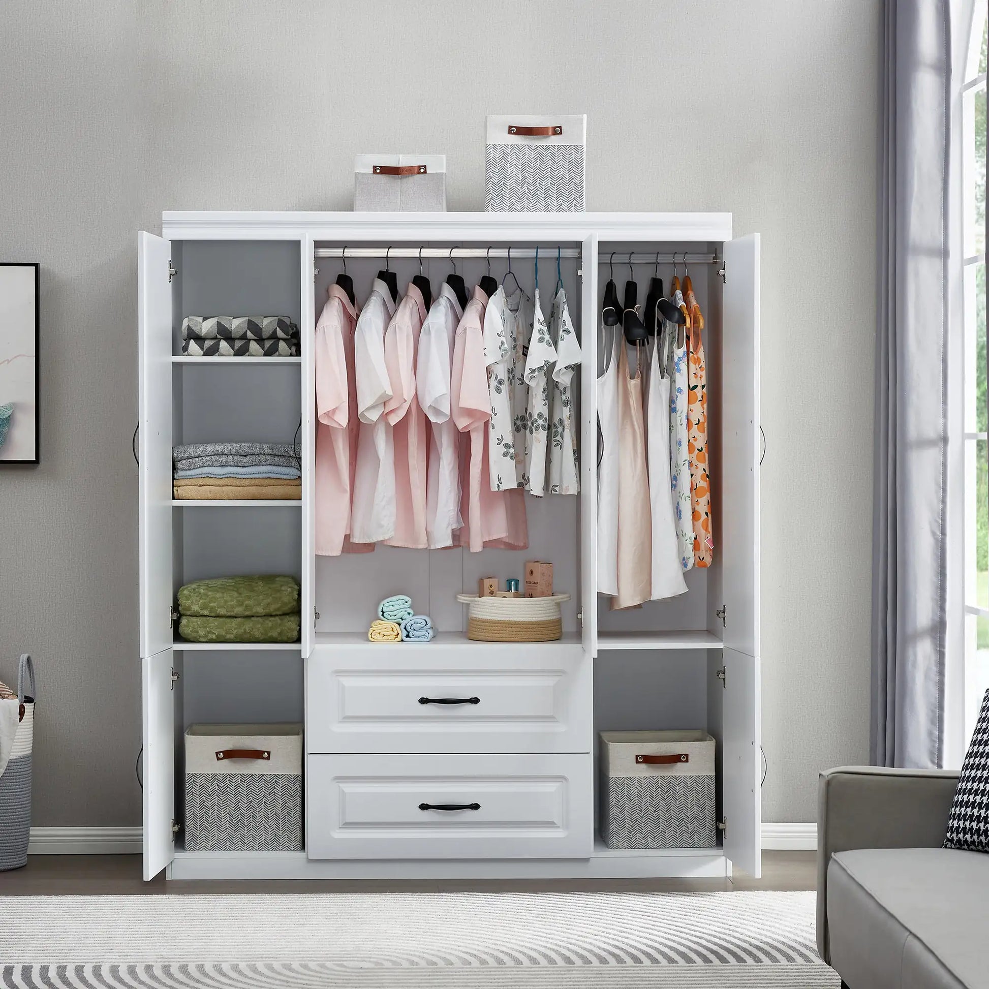 White solid wood wardrobe closet with open doors showing hanging clothes, shelves, and drawers