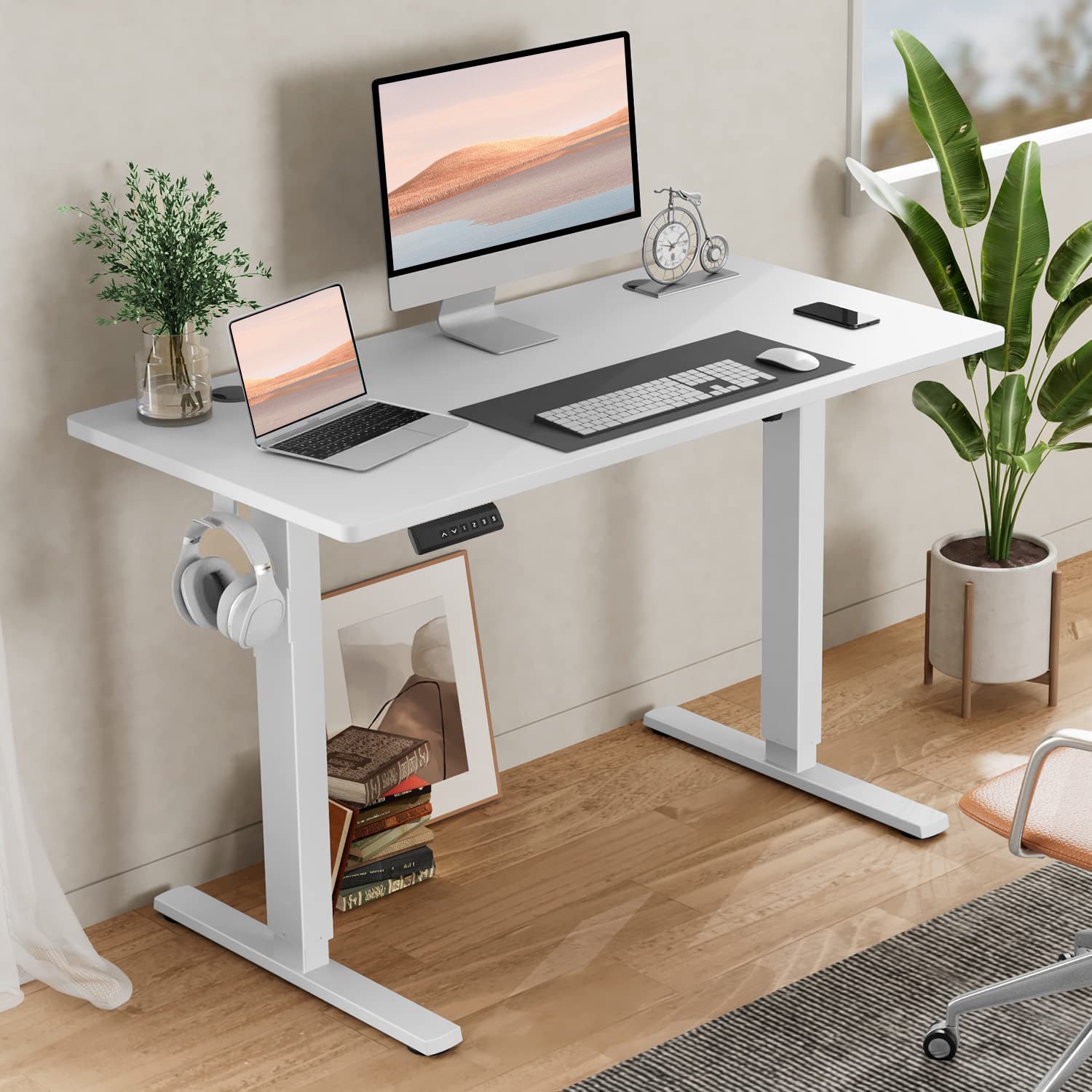 Shopi Vella white standing desk for home office with adjustable height, computer, laptop, and plant