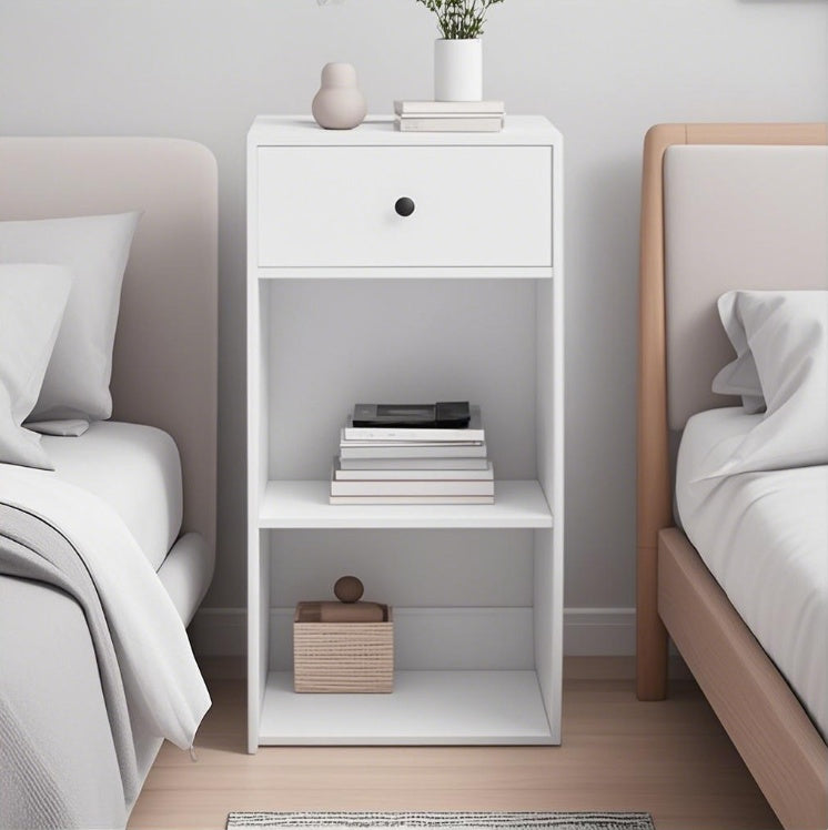 White storage cabinet with drawers and open shelves placed between two beds in a modern bedroom