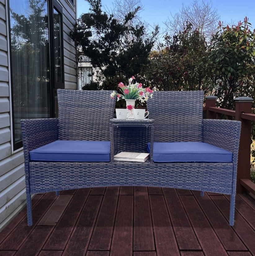 Shopi Vella wicker patio furniture set with blue cushions and built-in center table on wooden deck