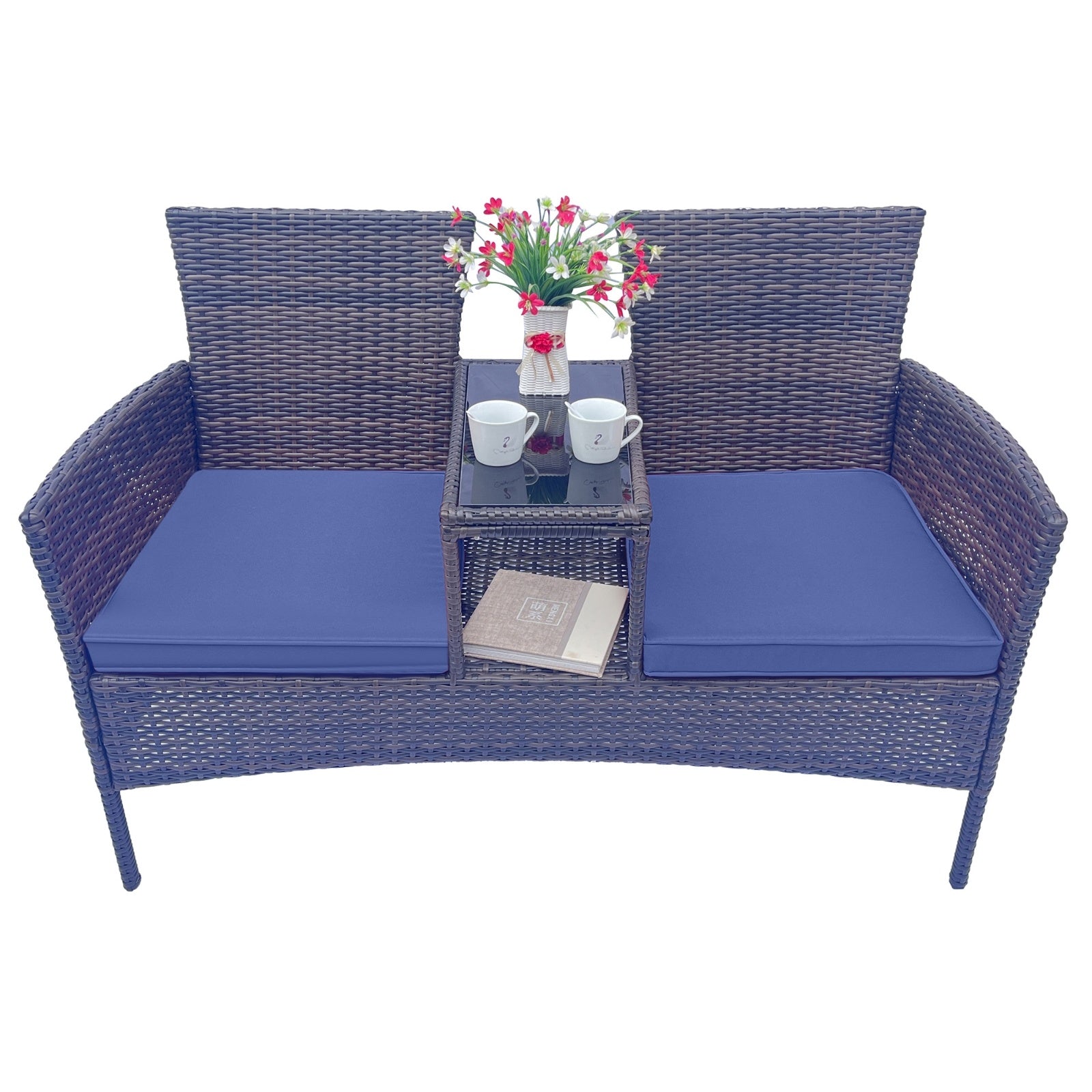 Shopi Vella wicker patio furniture set with blue cushions and center table holding mugs and flowers