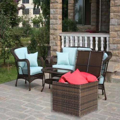 Shopi Vella wicker patio storage box with red cushions next to outdoor wicker patio furniture set