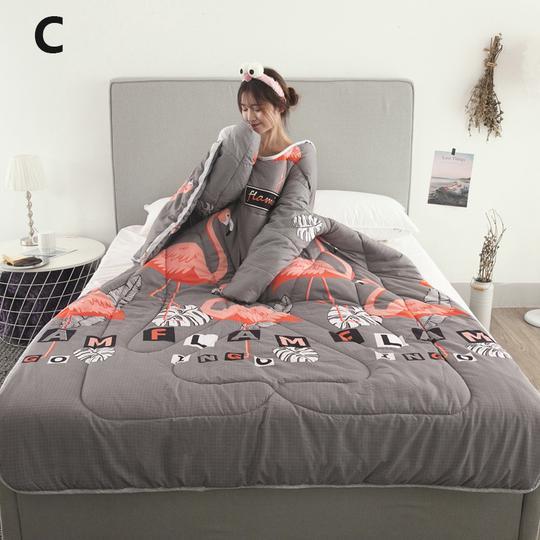 Shopi Vella winter quilt with sleeves featuring flamingo design in gray and coral colors