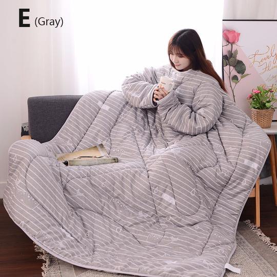 Gray winter quilt with sleeves by Shopi Vella featuring cozy striped design for indoor comfort