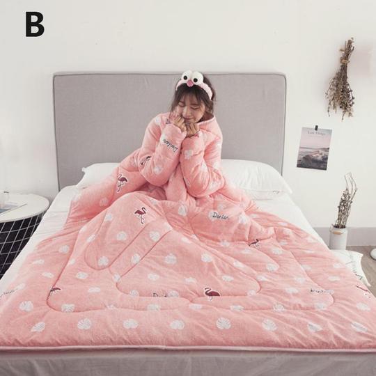 Shopi Vella pink winter quilt with sleeves featuring flamingo and shell patterns on bed