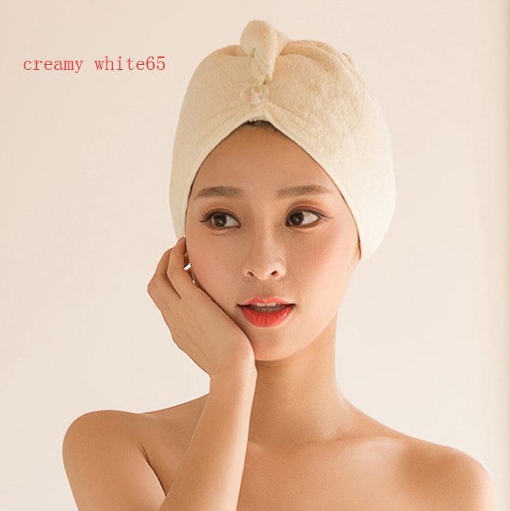 Creamy white women's hair drying towel wrapped around a woman’s head for quick hair drying