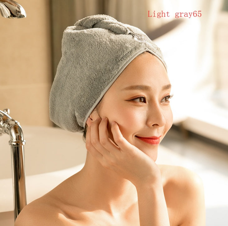 Light gray women's hair drying towel wrapped on woman’s head for quick hair drying