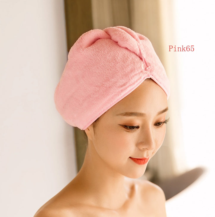 Soft pink women's hair drying towel wrapped around woman's head for quick hair drying