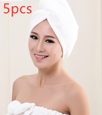 Woman wearing white women's hair drying towel wrapped around her head smiling