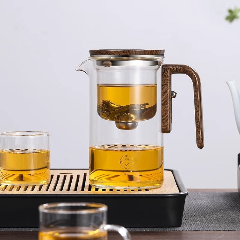 Shopi Vella wood handle tea separation pot with clear glass brewing chamber and wooden lid on a tray