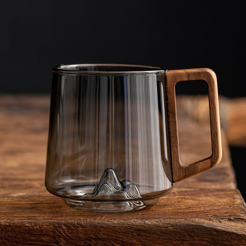 Shopi Vella wooden handle glass cup with mountain design inside on rustic wooden surface