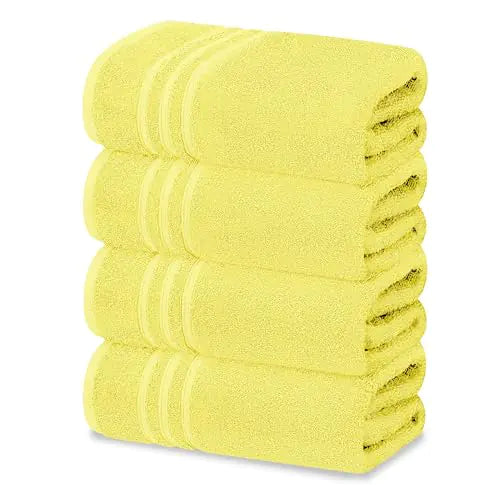 Stack of soft yellow quick dry towels set neatly folded for home or gym use